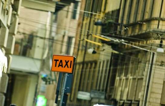 taxi sign on road with city background