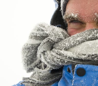 Young man in winter storm with frozen eyebrows