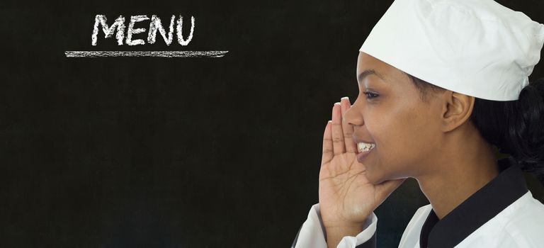 Chef with chalk menu sign written on blackboard background