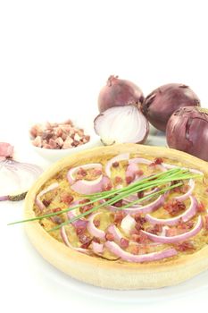 Onion tart with leeks on a light background