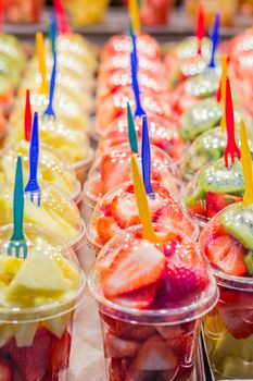 Set packed slice of fresh fruits in the famous La Boqueria market, Ramblas street, Barcelona, Spain