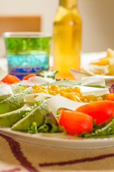 Traditional mexican food in table, with fresh salad plate and bowl of nachos