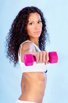 Young woman with long curled hair doing fitness exercises