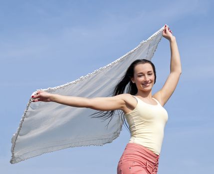 woman holding white cloth in wind 