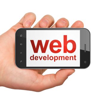 SEO web development concept: hand holding smartphone with word Web Development on display. Generic mobile smart phone in hand on White background.