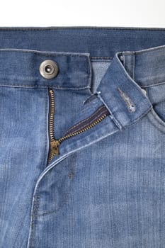 Close up image of denim jeans pocket with a ripped hole