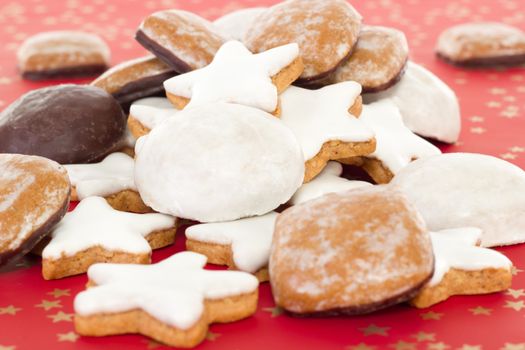 Mixed christmas cookies on red background with golden stars