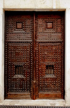 Wooden  door of ancient church of San Roque in Chinchon, Madrid, Spain