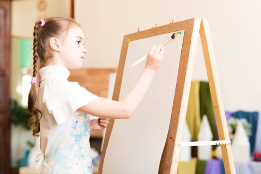 portrait of a girl standing next to his easel, a drawing lesson