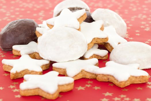 Mixed christmas biscuits on red background with golden stars