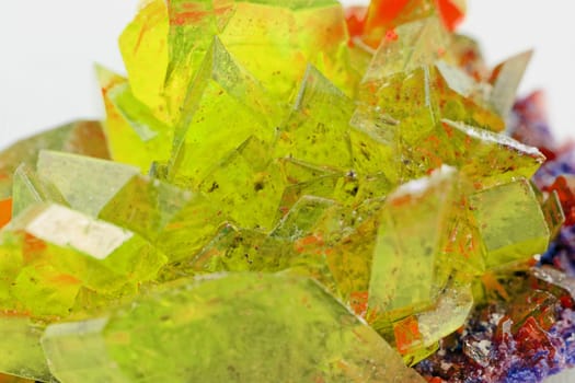 Close up picture about a crystal with topaz color on white background (yellow crystal)