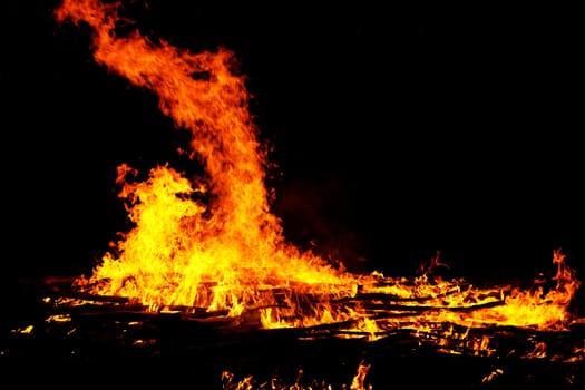 red flames of huge bonfire or campfire as black backgorund