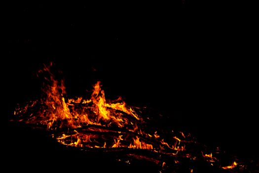 red flames of huge bonfire or campfire as black backgorund