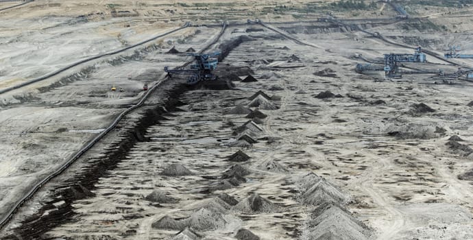 Coal mining in an open pit with huge industrial machine