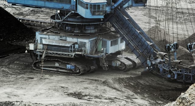 Coal mining in an open pit with huge industrial machine