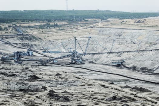 Coal mining in an open pit with huge industrial machine