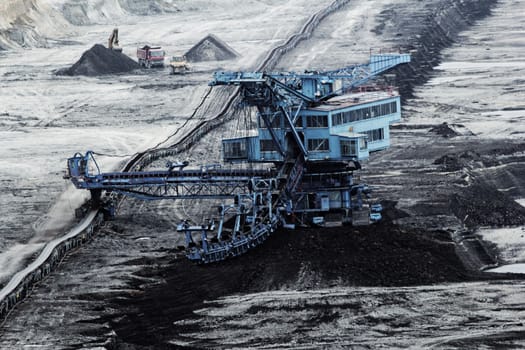 Coal mining in an open pit with huge industrial machine