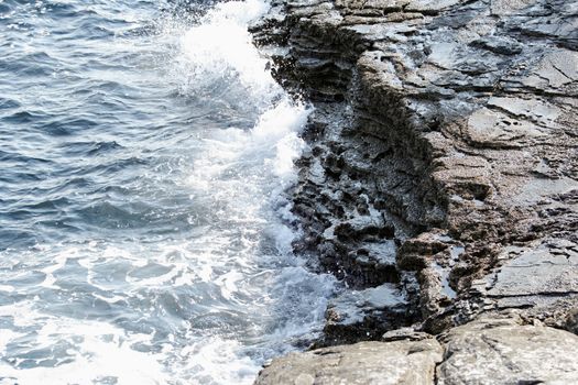 the rocky beach breaks the huge waves