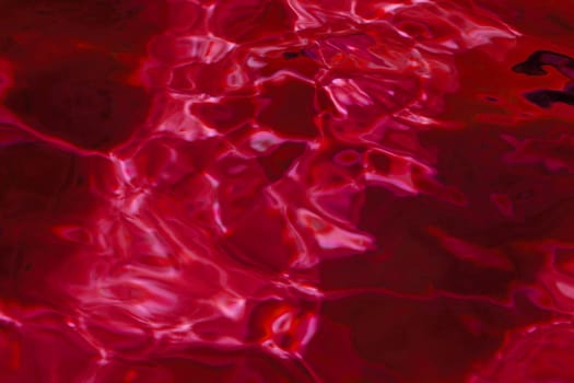 red abstract background of wavy water surface