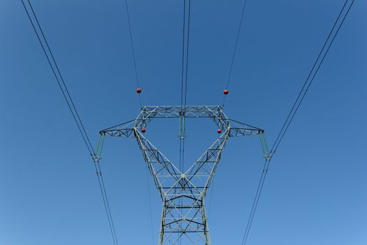 Detail of electricity pylon against blue sky 