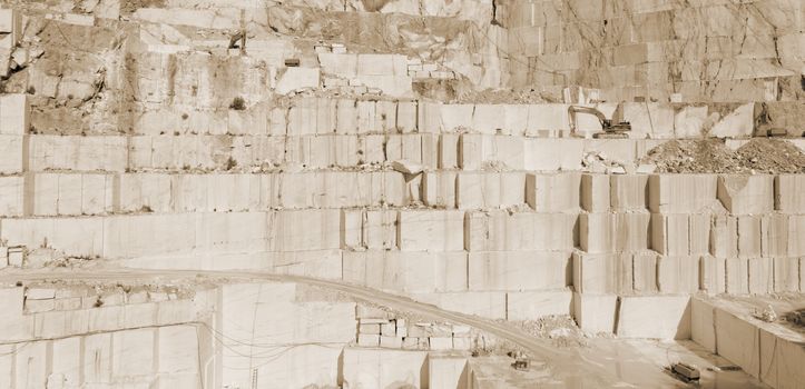 Detail of huge Thassos white marble quarry (mine) with grabber sepia