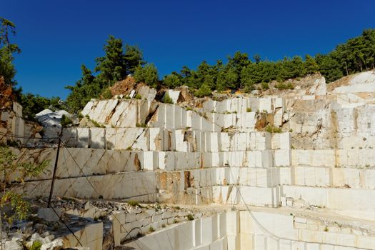 Detail of huge Thassos white marble quarry (mine) with grabber