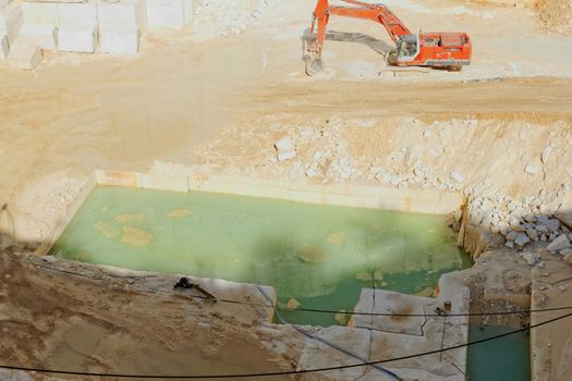 Detail of huge Thassos white marble quarry (mine) with grabber