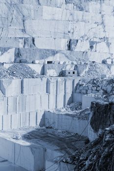 Detail of huge Thassos white marble quarry (mine) with grabber (color filtered photo) abstract