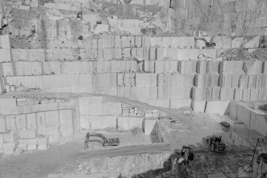 Detail of huge Thassos white marble quarry (mine) with grabber in bw color