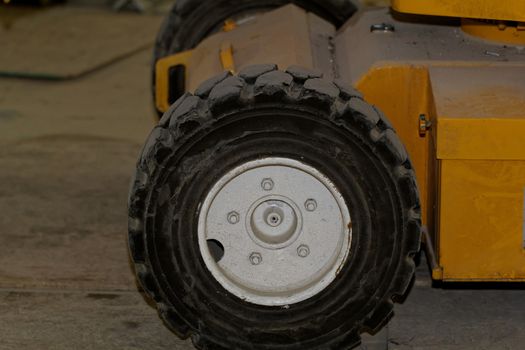 Yellow industrial machine with solid rubber wheel