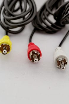 three audio (left - right) - video RCA cable and plug (red, white, yellow) on white background