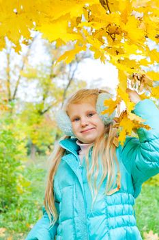 happy girl in autumn with leaves
