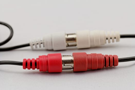 correct conection between left - right audio RCA cable on a white background (red white)