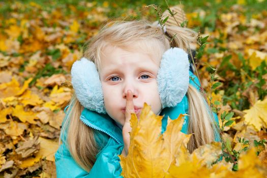 girl showing silence in autumn