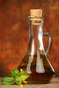 bottle with olive oil and basil leaves