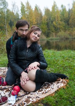 Beautiful loving couple in the Park in autumn picnic