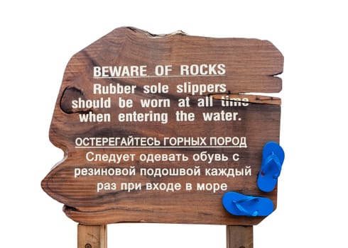 wood warning sign on beach