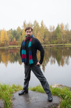 man with glasses on a background of autumn forest