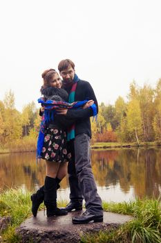 Beautiful loving couple dancing at a lake in autumn