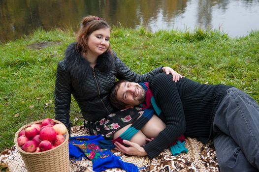 Beautiful loving couple in the Park in autumn picnic