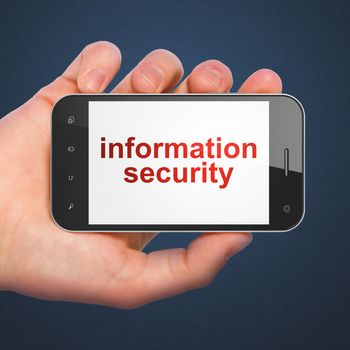 Safety concept: hand holding smartphone with word Information Security on display. Generic mobile smart phone in hand on Dark Blue background.
