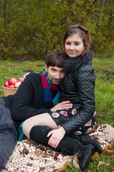 Beautiful loving couple in the Park in autumn picnic