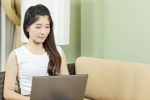 Asian young business woman working on laptop or notebook