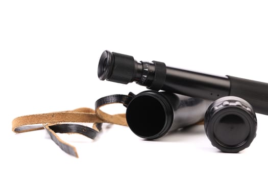Black cover and spyglass lying on a white background