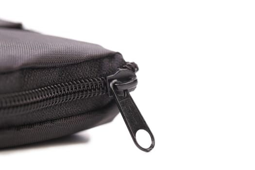Plastic black zipper of case. White background.