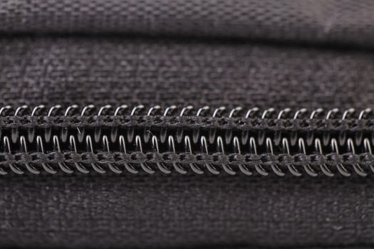 Plastic black zipper of case. Macro. Whole background.