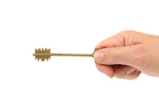 Hand holds bronze steel key. White background.