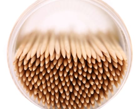 toothpicks in a round box, top view, isolated on white background.