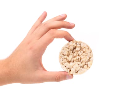 Hand holds corn crackers. Close up. White background.