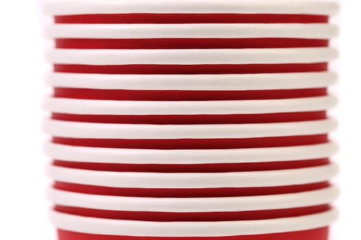 Pile of colorful paper coffee cup. Close up. White background.